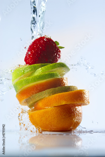 water splashing over sliced fruits