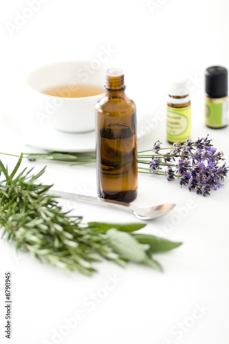 Herbal medicine and a cup of tea. Isolated on white.