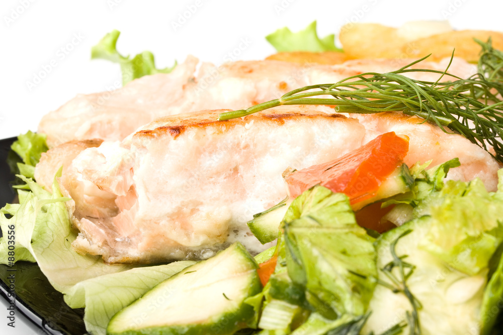 Stake from a salmon with vegetables on a plate. Closeup. Stake from a salmon with vegetables on a plate. Closeup.