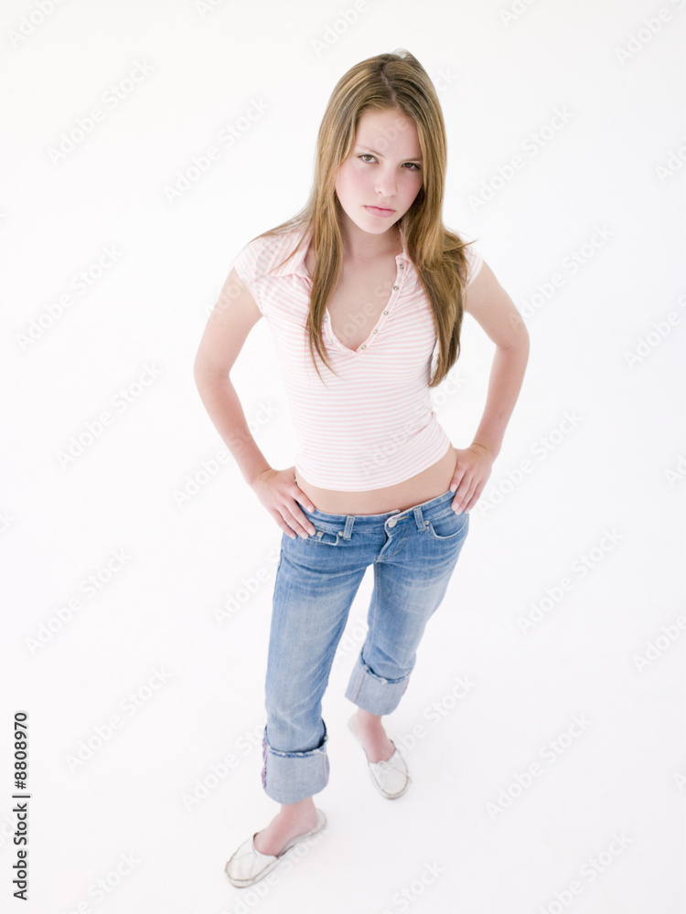 Teenage girl with hands on hips frowning Teenage girl with hands on hips frowning