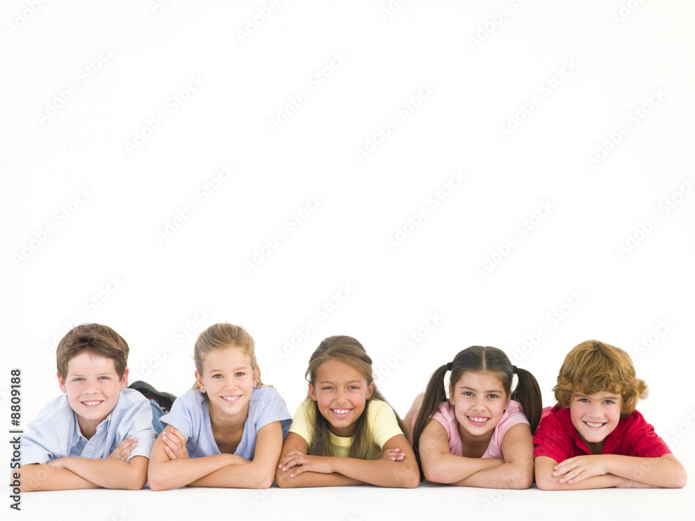 Row of five friends lying down smiling Row of five friends lying down smiling
