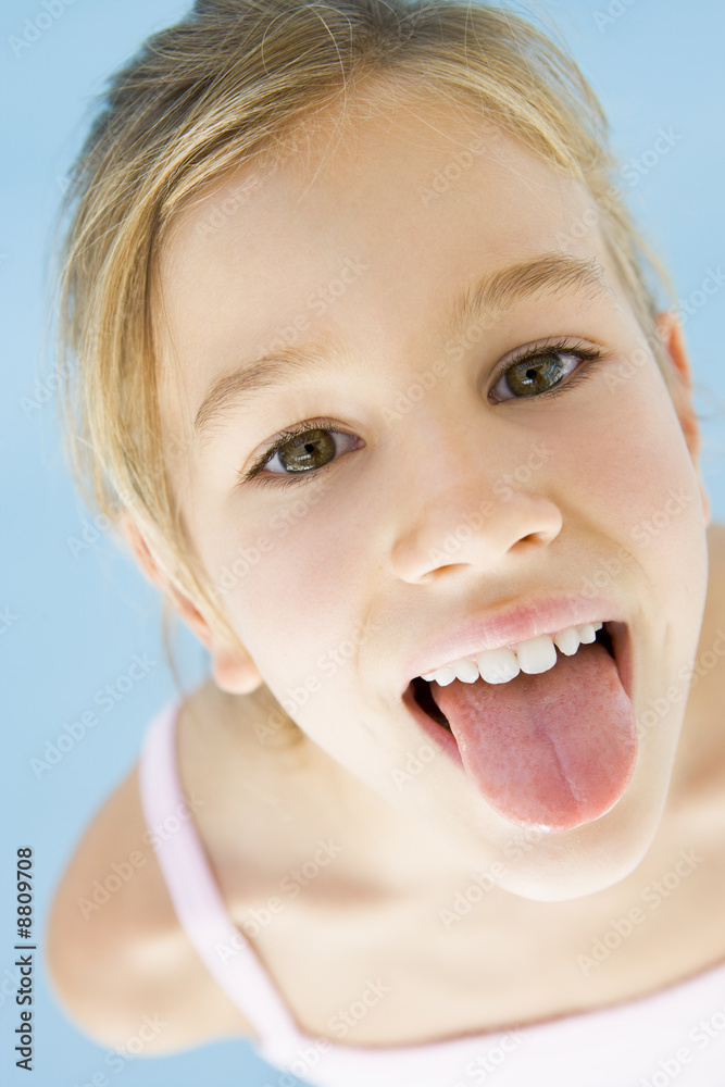 Young girl sticking her tongue out Stock-Foto | Adobe Stock