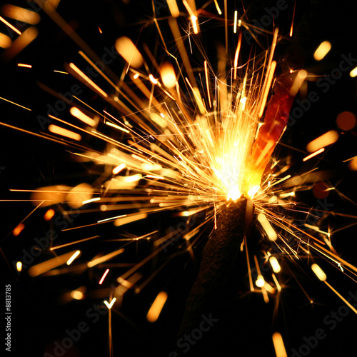 yellow sparkler holiday background on black