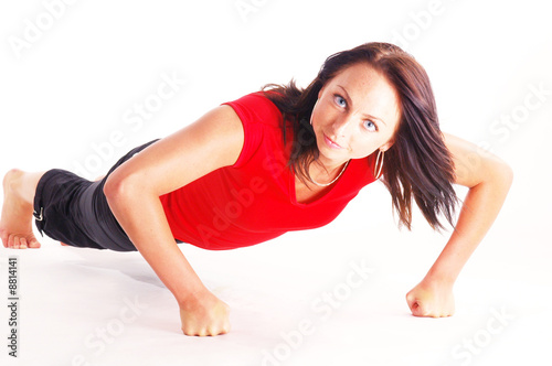 A young pretty slim woman doing excersise photo