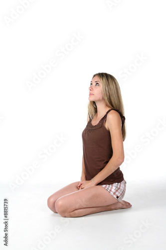 teenage girl kneeling and looking up