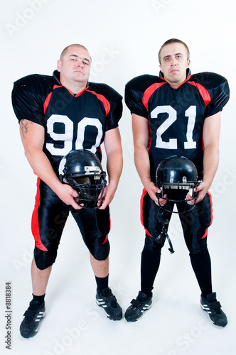 American football players holding helmets © kiri