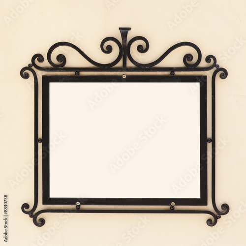 Old-fashioned iron frame on the wall