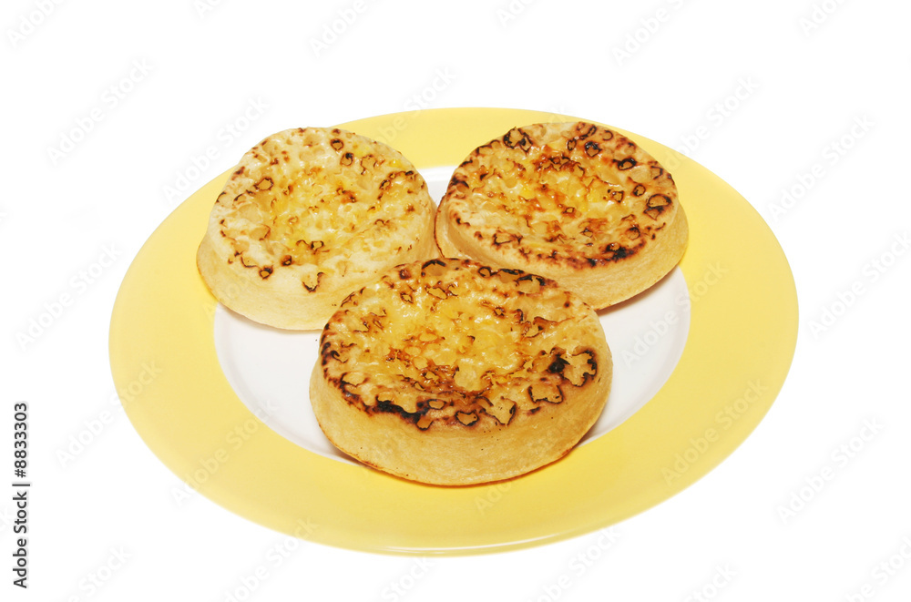 Three crumpets on a plate Three crumpets on a plate
