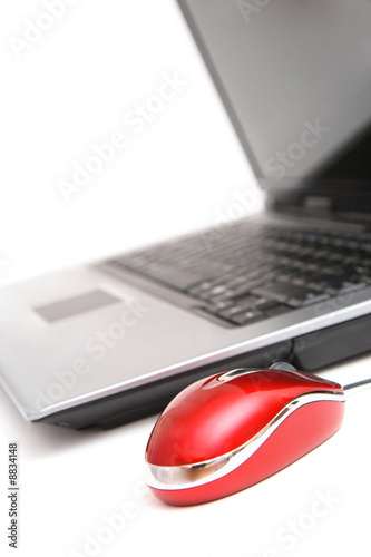 personal computer and red mouse over white