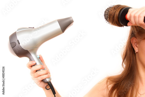 female hand holding hairdryer over white background