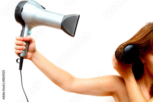female hand holding hairdryer over white background