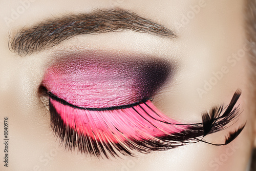 Macro eye of a woman with pink smoky eyeshadow #8840976