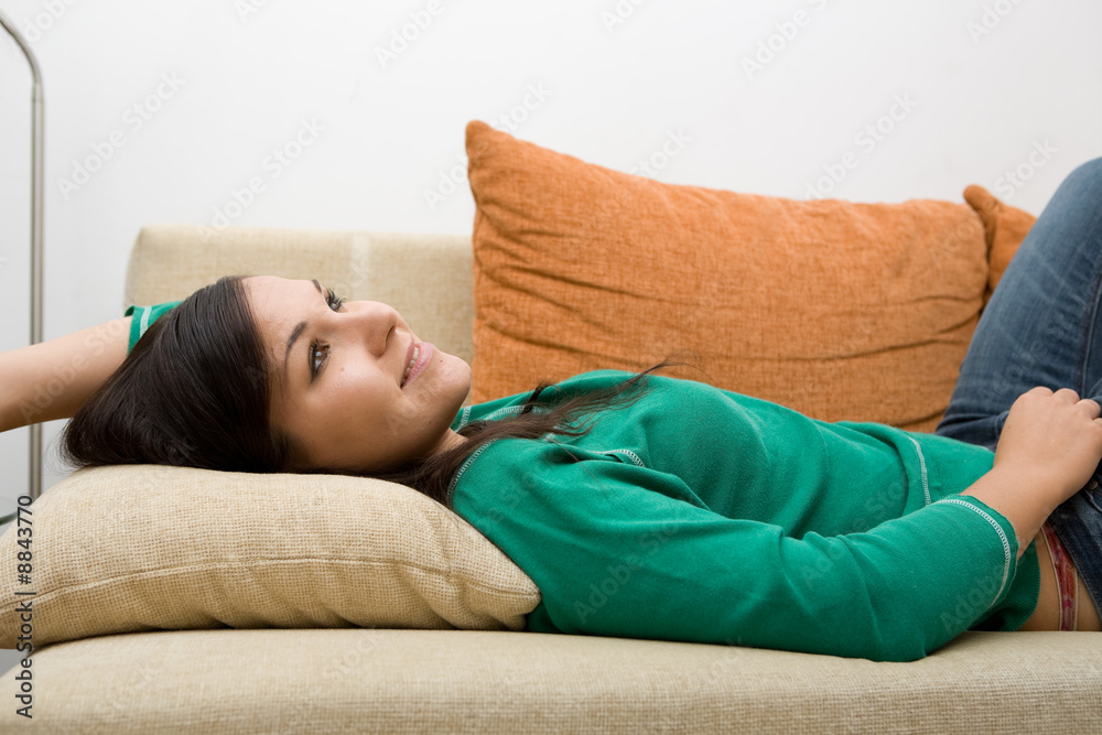attractive brunette woman lying on sofa attractive brunette woman lying on sofa