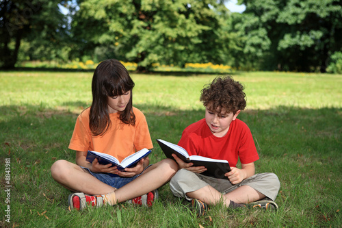 Kids reading book outdoor