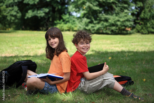 Kids reading book outdoor © Jacek Chabraszewski