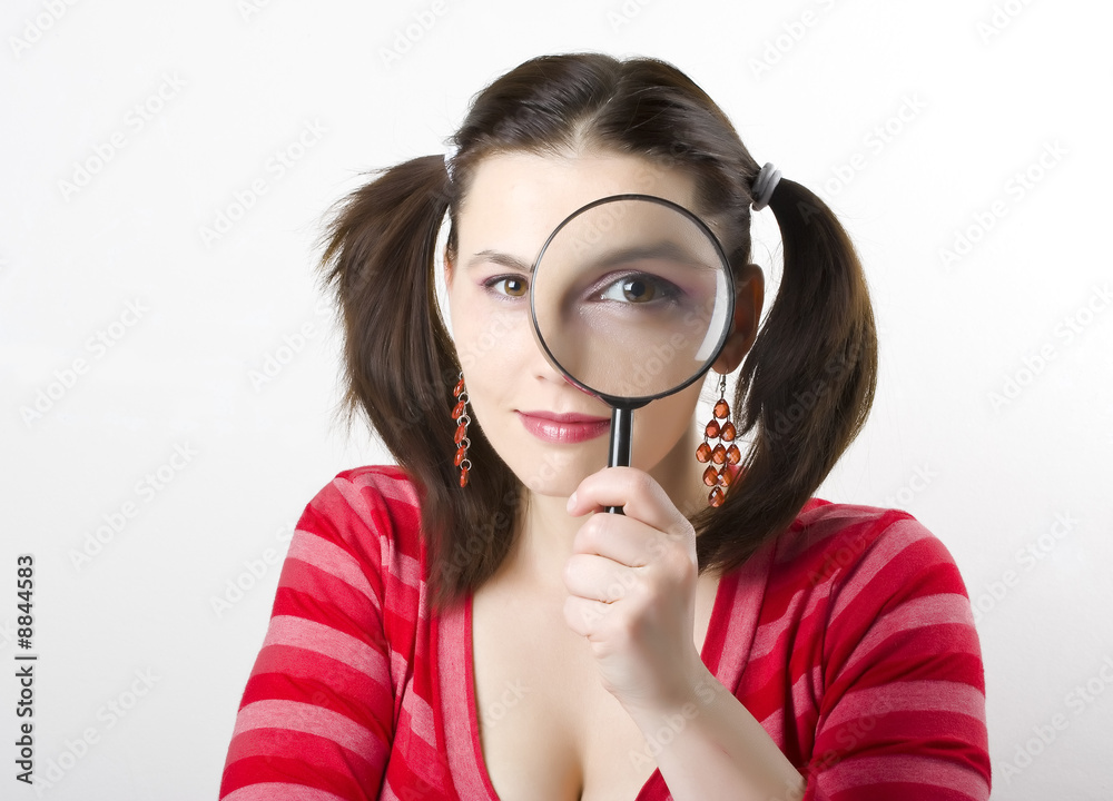 pretty young woman looking through magnifying pretty young woman looking through magnifying