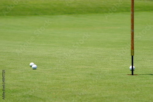 golf balls near the flagstick