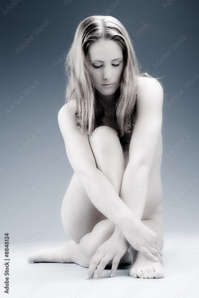 Fototapeta premium Young woman posing nude in the studio