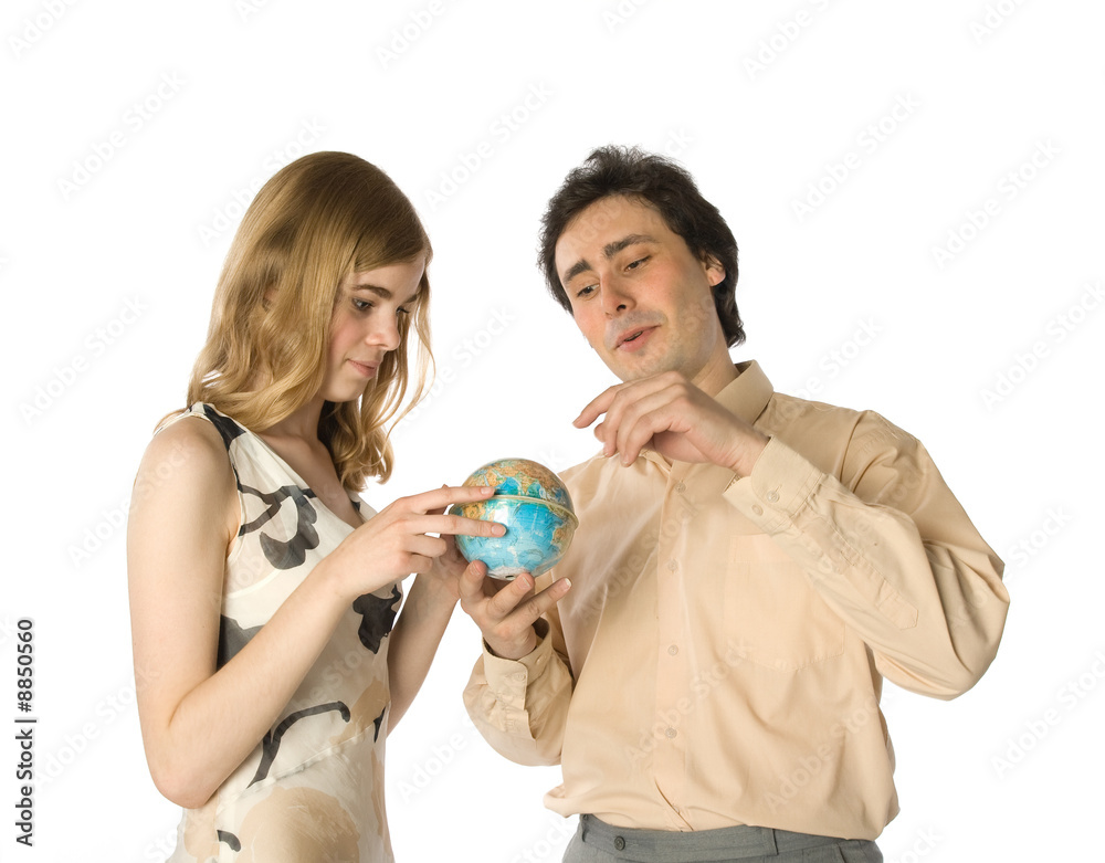 A couple looking at a small globe A couple looking at a small globe