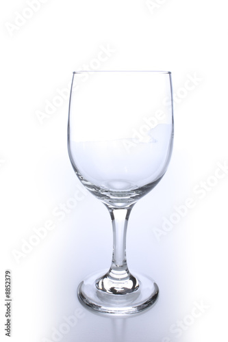 Empty crystal wine glass with light reflection