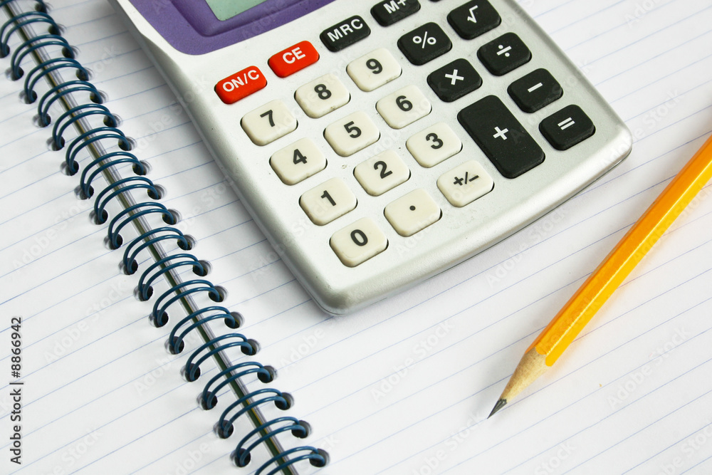 Calculator and yellow pencil on notebook Calculator and yellow pencil on notebook