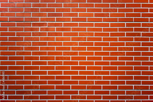 Photo of a red brick wall pattern.