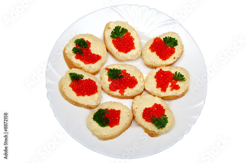 Small russian sandwiches with bread, butter and red caviar