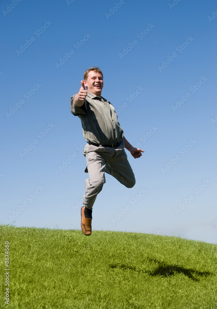 jumping businessman with his thumb up jumping businessman with his thumb up