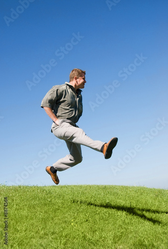 happy jumping businessman on the hill