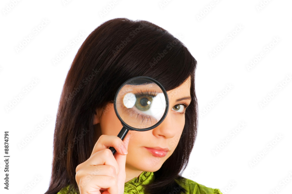 Girl's eye magnified through magnified glass on white Girl's eye magnified through magnified glass on white