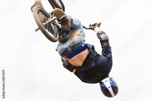 A BMX (Bicycle Moto-cross(X)) in the air against a clouded sky
