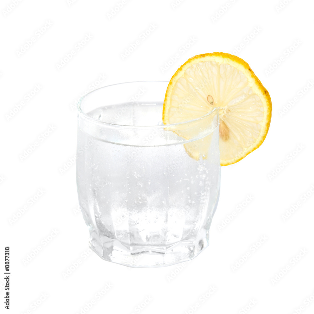 A cold water glass with lemon isolated on white. A cold water glass with lemon isolated on white.