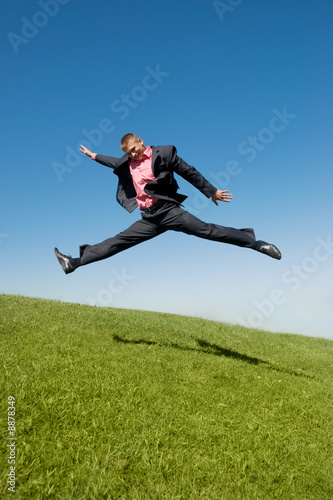 businessman rushing to work against blue sky