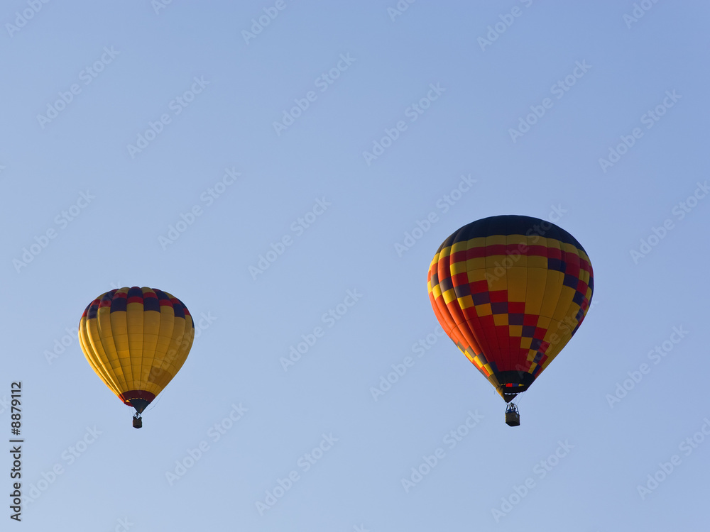 Fototapeta premium two hot air balloons in german colors in blue sky