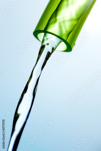 Tablou pe pânză water flowing from a garden hose against the light of the sun
