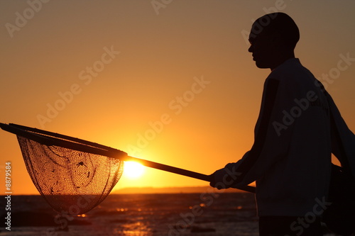 Pêcheur au coucher de soleil photo