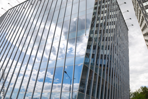 Modern office building with sky reflection in windows