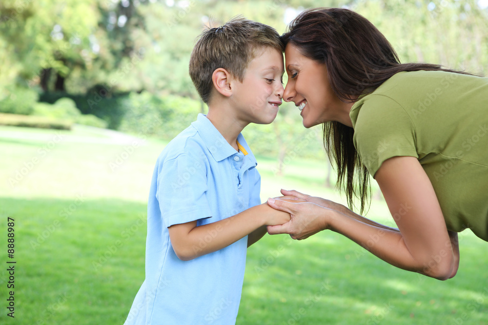 Obraz premium A mother and son having fun while playing in the park