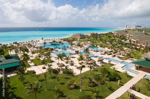 Luxury tropical oceanfront resort, pools and lush grounds