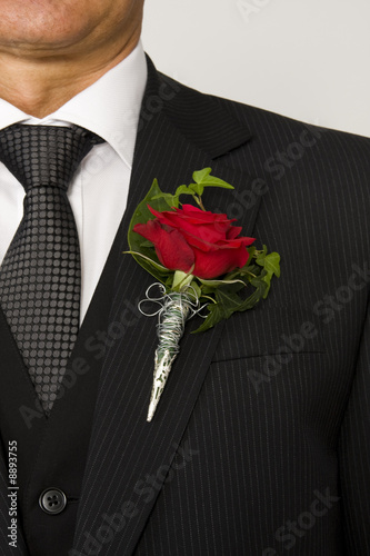 red rose on suit jacket of groom photo