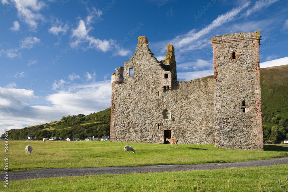 Lochranza Castle with animals in evening sunlight