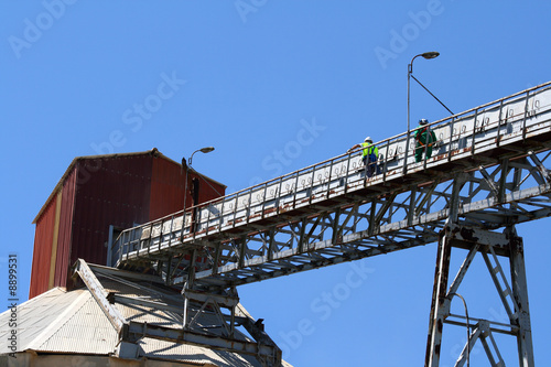 Two workers go up on an old factory
