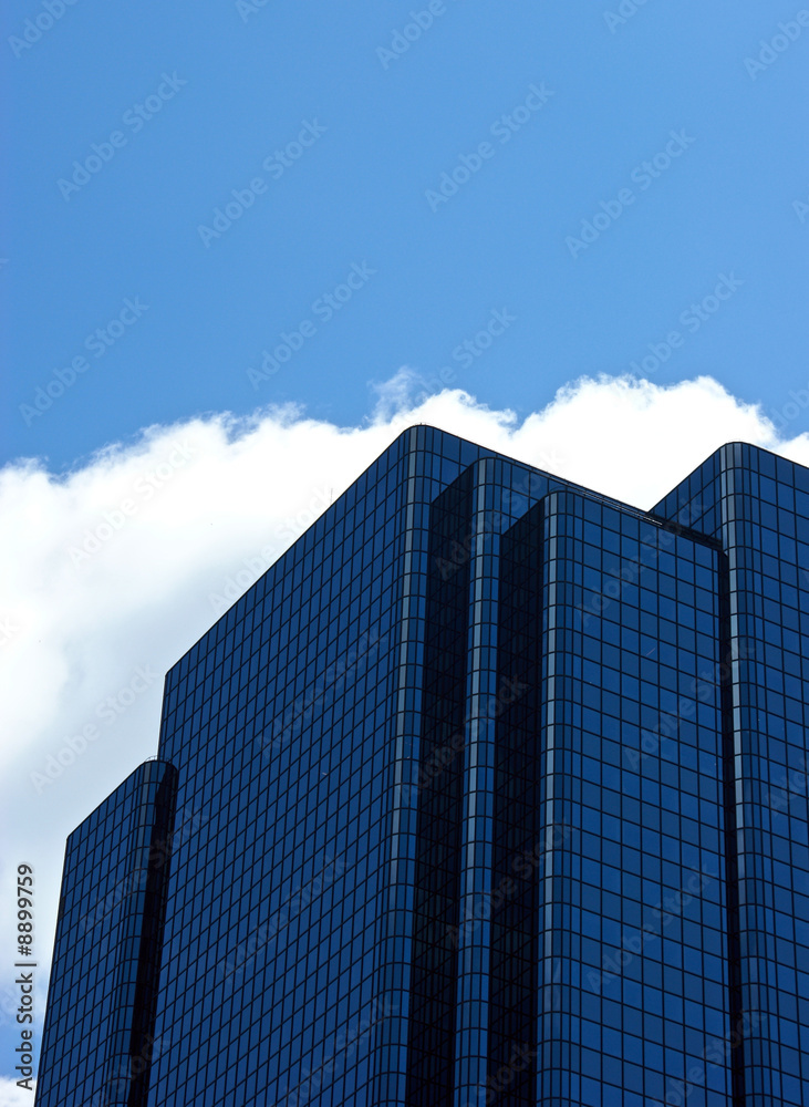 angular blue glass office building with rounded edges