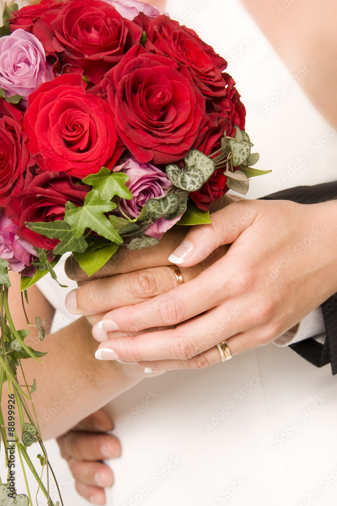 The bride and bridegroom holding a wedding bouquet The bride and bridegroom holding a wedding bouquet
