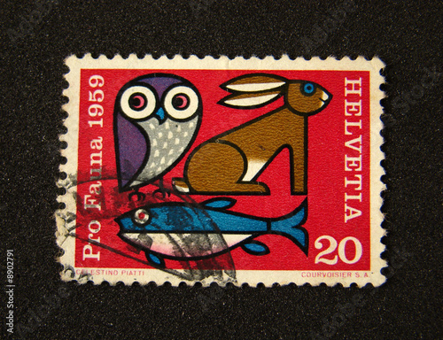 Helvetia (Switzerland) postage stamp on black background.
