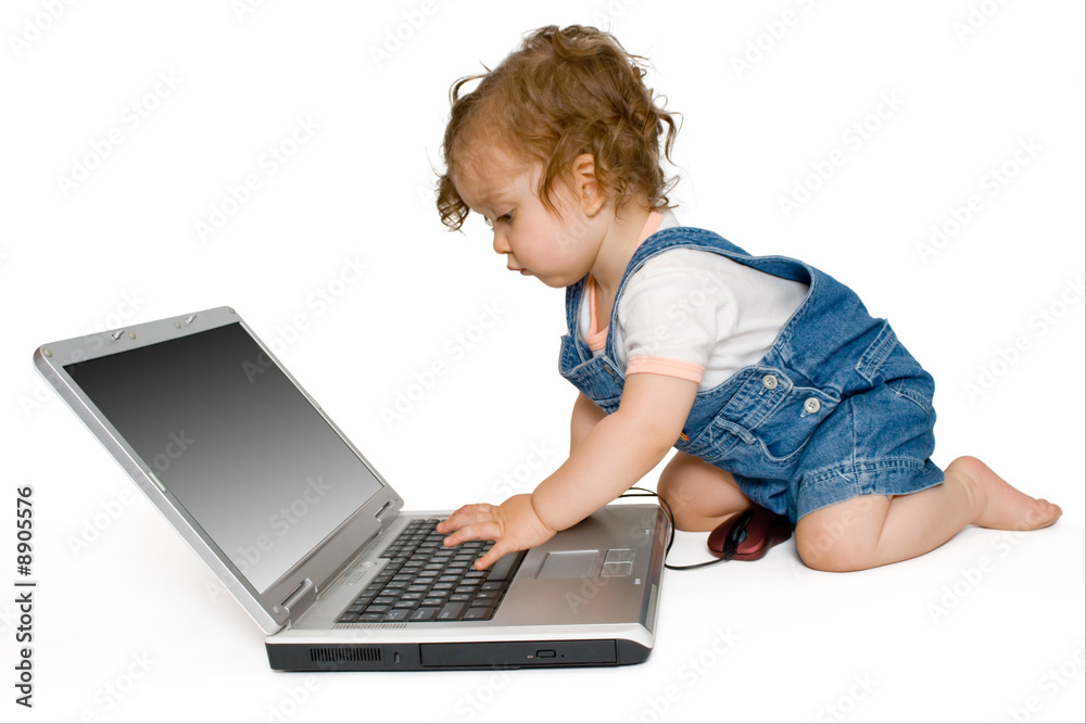 Baby girl working with laptop, isolated, on white background Baby girl working with laptop, isolated, on white background