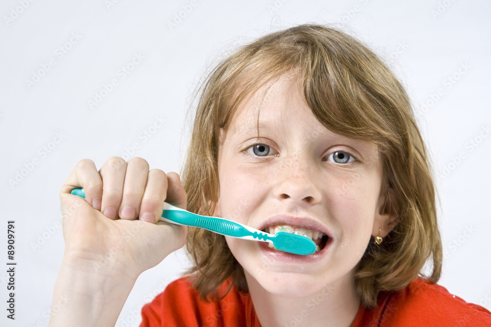 Little girl wearing colorful t-shirts brushing teeth Little girl wearing colorful t-shirts brushing teeth