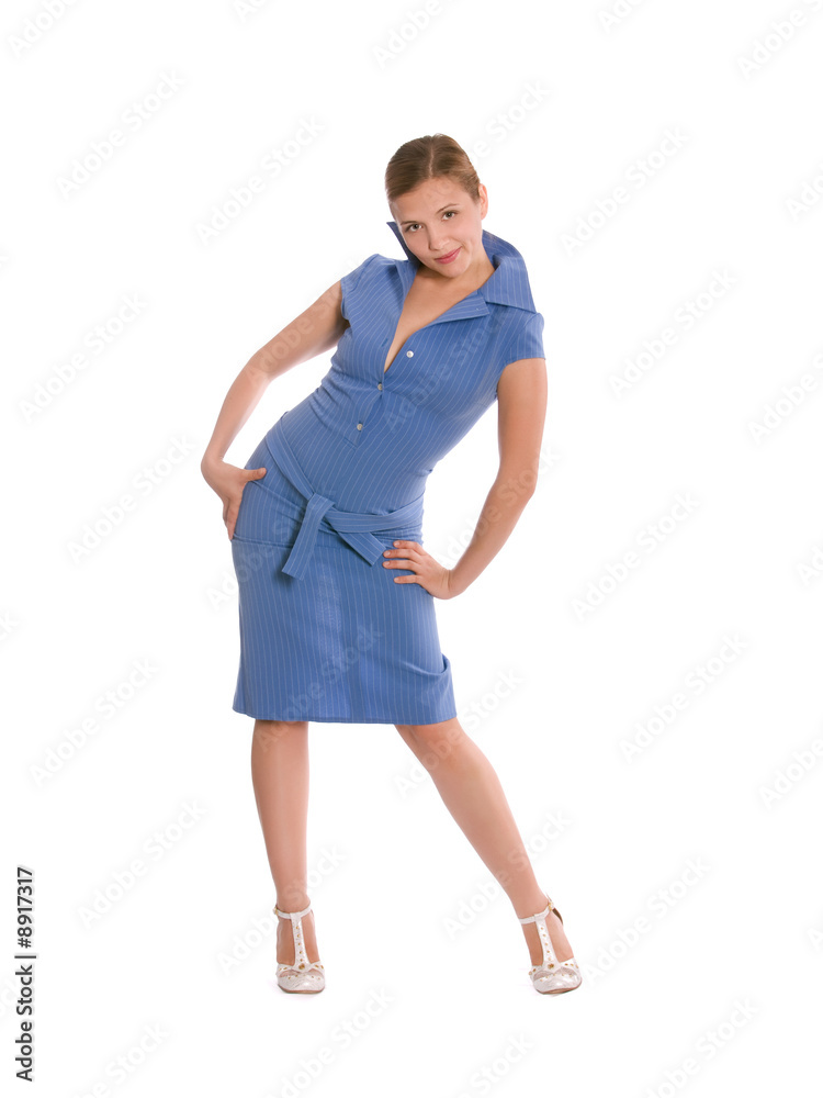 Young woman in blue dress bent playfully with arms on her side. Young woman in blue dress bent playfully with arms on her side.