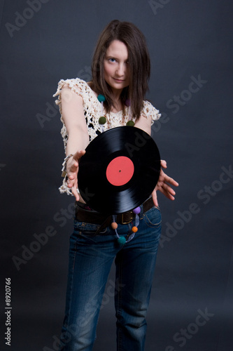 The young woman holds vinyl. Studio shooting