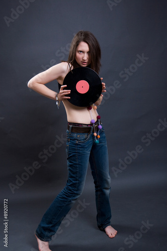 The young woman holds vinyl. Studio shooting